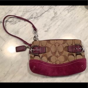 Medium Coach wristlet with pink/maroon accents